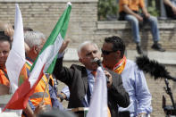 Leader of the Orange Vests movement, Antonio Pappalardo, addresses a rally in Rome, Tuesday, June 2, 2020. Hundreds of protesters shunning masks gathered in Rome's Piazza del Popolo on Tuesday to demonstrate against the government measures taken to stop the spread of coronavirus. The so-called Orange Vests, a marginal political movement created last year by a retired Carabinieri general, have emerged as virus-denial camp in Italy, the first Western country to be hit by the global pandemic. (AP Photo/Alessandra Tarantino)