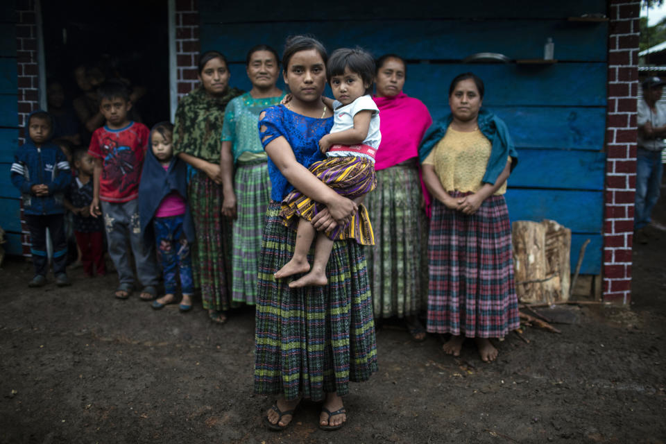Ofelia Cal Jom, 14, holds her 9-year-old sister Dora, as they pose for a photo in the makeshift settlement Nuevo Queja, Guatemala, Tuesday, July 6, 2021. Ofelia and Dora are the only survivors of their family who perished in a mudslide triggered by Hurricane Eta in November 2020. (AP Photo/Rodrigo Abd)