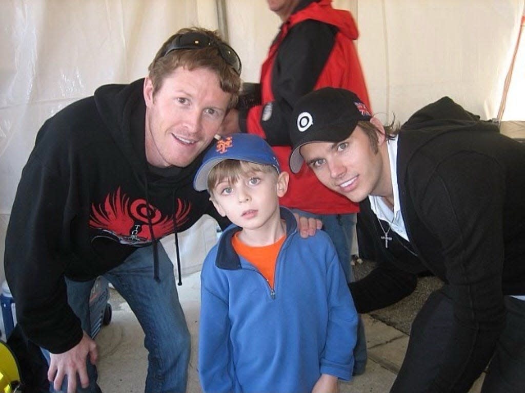 Palm Beach's Max Esterson, then about 5 years old, with drivers Scott Dixon and Dan Wheldon.