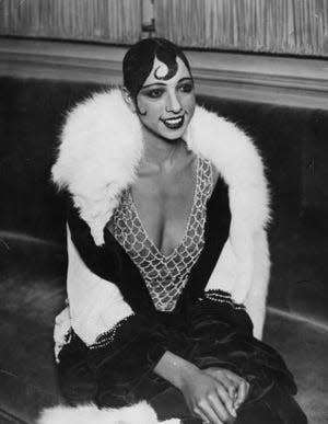 Josephine Baker black and white photo with plastered curls, white fox fur wrap and long sleeve dress