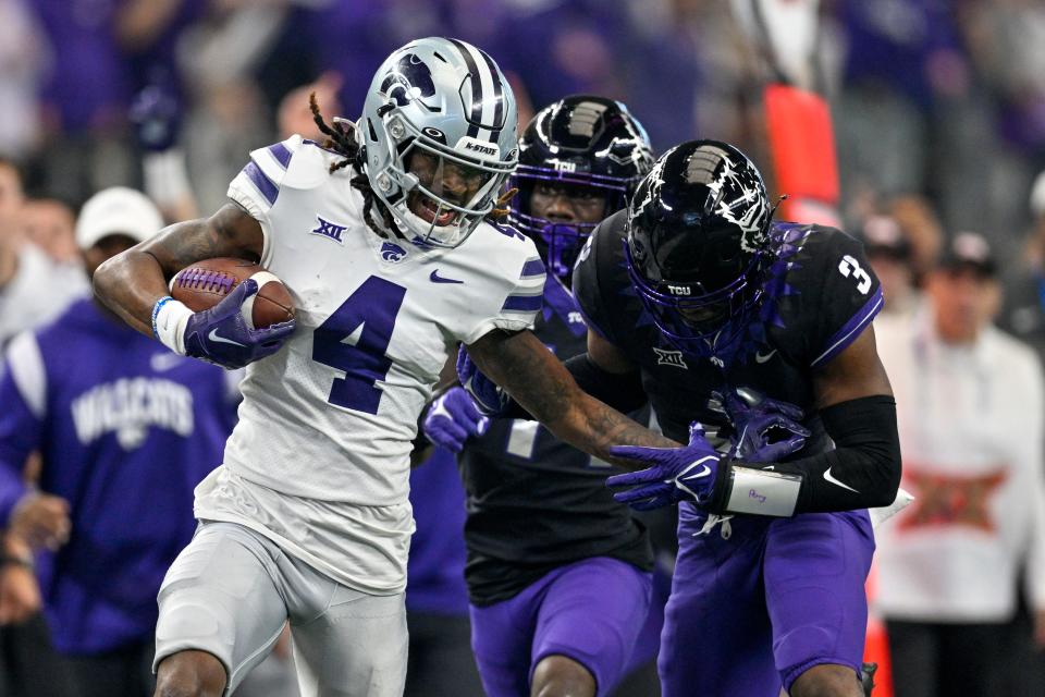 Kansas State wide receiver Malik Knowles (4) tries to break free from TCU's Mark Perry (3) during the 2022 Big 12 championship game at AT&T Stadium.