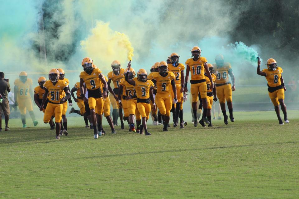 Ed White enters the field for a matchup against Trinity Christian on Aug. 26, 2022.