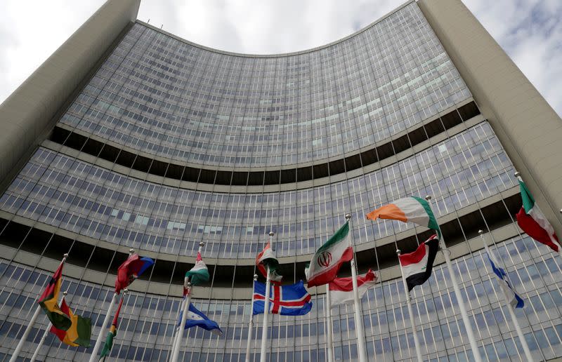 An Iranian flag flutters amongst other flags in front of the IAEA headquarters in Vienna