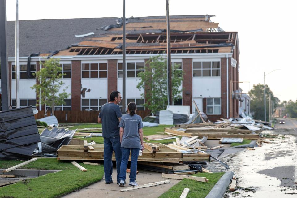 Claremore, Oklahoma residents survey damage to a church on Sunday. The powerful storms damaged dozens of buildings in the small town (AP)