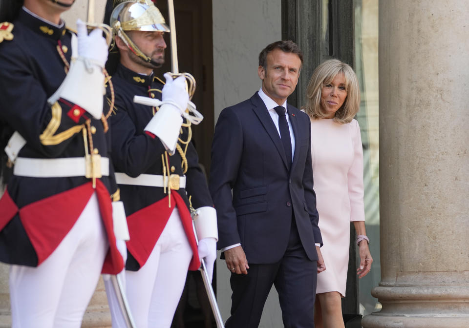 France's President Emmanuel Macron, left, and his wife Brigitte Macron, left, await United Arab Emirates' President Sheikh Mohammed Bin Zayed at the Elysee Palace in Paris, Monday, July 18, 2022. United Arab Emirates' President Sheikh Mohammed Bin Zayed is for a two-days visit in France. (AP Photo/Michel Euler)