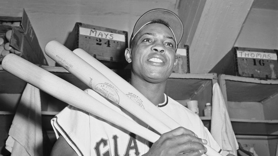 FILE - New York Giants' centerfielder Willie Mays flashes smile in clubhouse at the Polo Grounds in New York after clouting his 20th triple of the season in 1957. - AP
