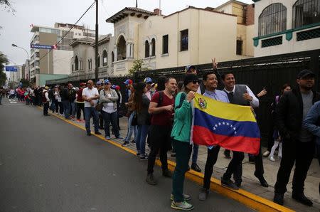 People wait to vote during an unofficial plebiscite against Venezuela's President Nicolas Maduro's government, in Lima, Peru, July 16, 2017. REUTERS/Mariana Bazo