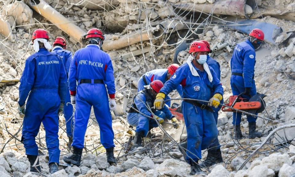 A Russian rescue team clears debris at the explosion site.