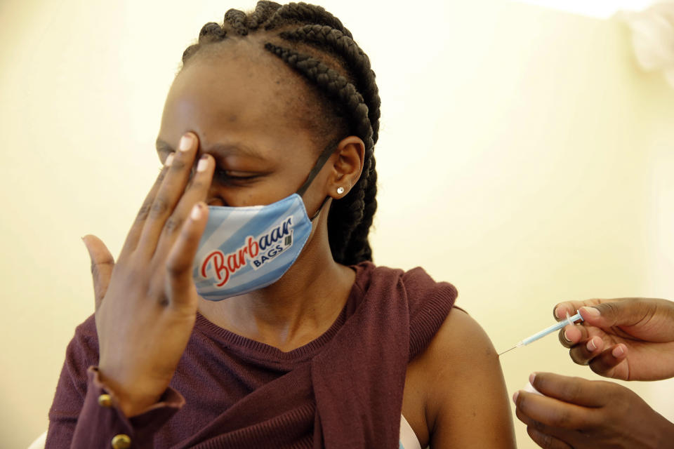 FILE - In this April 8, 2021, file photo, a woman at Kenyatta National Hospital in Nairobi, Kenya, receives a dose of AstraZeneca COVID-19 vaccine manufactured by the Serum Institute of India and provided through the global COVAX initiative. COVAX is providing vaccines to countries lacking the clout to negotiate on their own for scarce supplies, but in the past two weeks only 2 million doses have been cleared for shipment to 92 countries. (AP Photo/Brian Inganga, File)