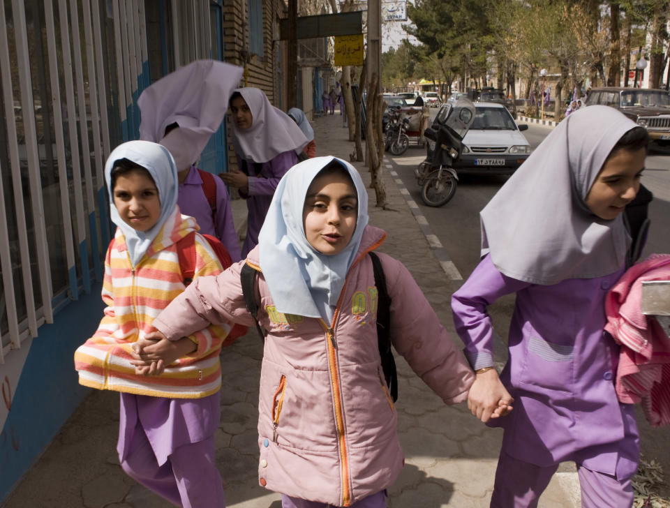 School girls walk down the street in Iranian President Mahmoud Ahmadinejad's birth village of Aradan, east of Tehran, March 12, 2008.&nbsp;