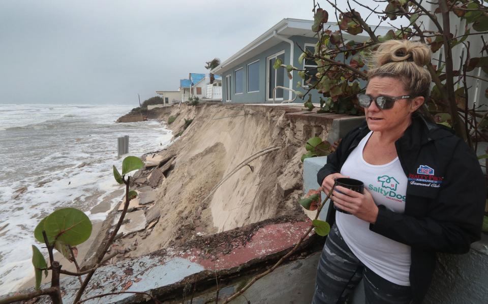 Krista Goodrich, property manager for Salty Dog Vacations, looks at the ocean as it slowly eats away at dunes behind a luxury home in the 4100 block of South Atlantic Avenue in Wilbur-by-the-Sea. Already badly damaged by Tropical Storm Ian, the house might not survive the impact of Tropical Storm Nicole expected arrival in the early hours of Thursday morning, she said.