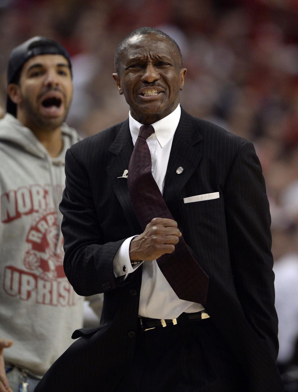 Toronto Raptors head coach Dwane Casey, right, and rapper Drake react near the end of a loss to the Brooklyn Nets in Game 7 of the opening-round NBA basketball playoff series in Toronto, Sunday, May 4, 2014. (AP Photo/The Canadian Press, Frank Gunn)