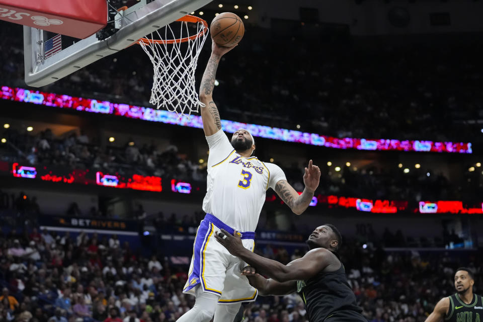 Los Angeles Lakers forward Anthony Davis (3) goes to the basket over New Orleans Pelicans forward Zion Williamson (1) in the first half of an NBA basketball game in New Orleans, Sunday, April 14, 2024. (AP Photo/Gerald Herbert)
