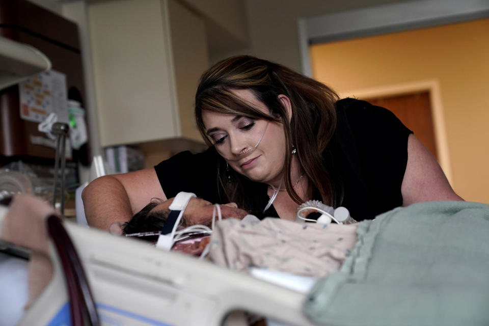 Lauren Debroeck, who is on oxygen as she recovers from COVID-19, talks to her husband, Michael, who also contracted COVID-19 and is being kept alive with the help of an oxygenation machine, at the Willis-Knighton Medical Center in Shreveport, La., Wednesday, Aug. 18, 2021. (AP Photo/Gerald Herbert)