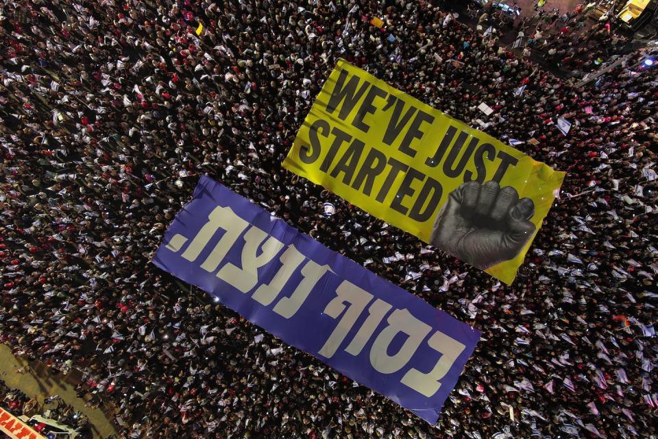 Israelis protest moves by Prime Minister <span class="caas-xray-inline-tooltip"><span class="caas-xray-inline caas-xray-entity caas-xray-pill rapid-nonanchor-lt" data-entity-id="Benjamin_Netanyahu" data-ylk="cid:Benjamin_Netanyahu;pos:4;elmt:wiki;sec:pill-inline-entity;elm:pill-inline-text;itc:1;cat:Politician;" tabindex="0" aria-haspopup="dialog"><a href="https://search.yahoo.com/search?p=Benjamin%20Netanyahu" data-i13n="cid:Benjamin_Netanyahu;pos:4;elmt:wiki;sec:pill-inline-entity;elm:pill-inline-text;itc:1;cat:Politician;" tabindex="-1" data-ylk="slk:Benjamin Netanyahu;cid:Benjamin_Netanyahu;pos:4;elmt:wiki;sec:pill-inline-entity;elm:pill-inline-text;itc:1;cat:Politician;" class="link ">Benjamin Netanyahu</a></span></span> and his government to limit the power of the country’s Supreme Court. <a href="https://www.gettyimages.com/detail/news-photo/an-aerial-view-of-kaplan-street-as-israelis-gather-to-news-photo/1563351079?adppopup=true" rel="nofollow noopener" target="_blank" data-ylk="slk:Yair Palti/Anadolu Agency via Getty Images;elm:context_link;itc:0;sec:content-canvas" class="link ">Yair Palti/Anadolu Agency via Getty Images</a>