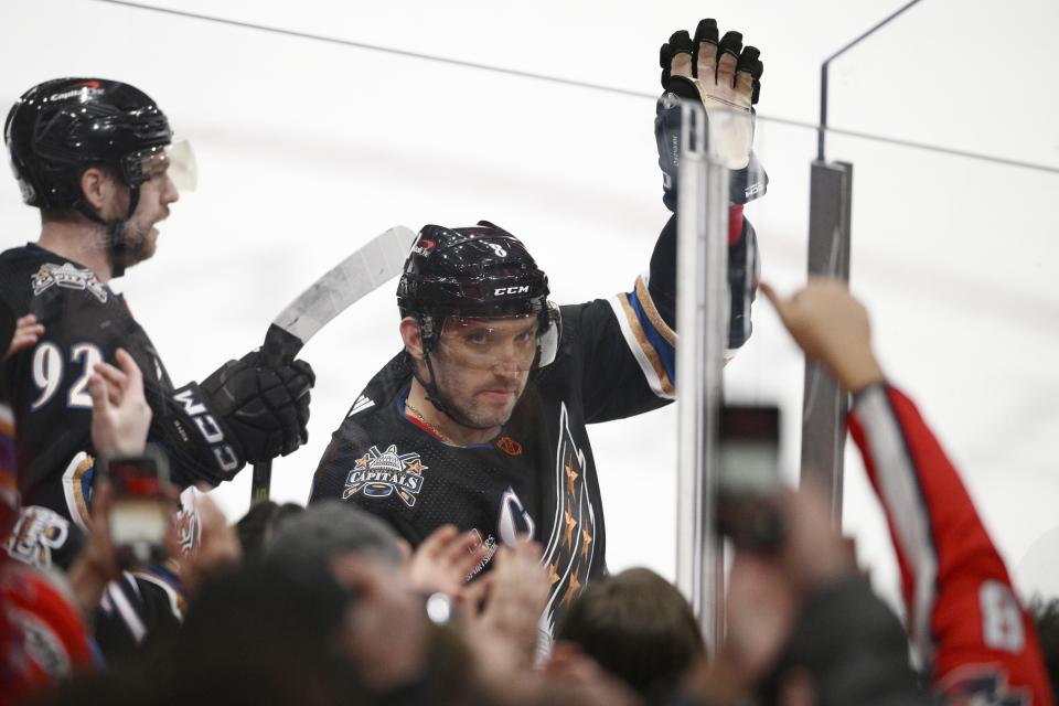 Washington Capitals left wing Alex Ovechkin (8) waves to the crowd as he was recognized for scoring his 801st NHL goal during the first period of an NHL hockey game against the Winnipeg Jets in Washington on Friday, Dec. 23, 2022.