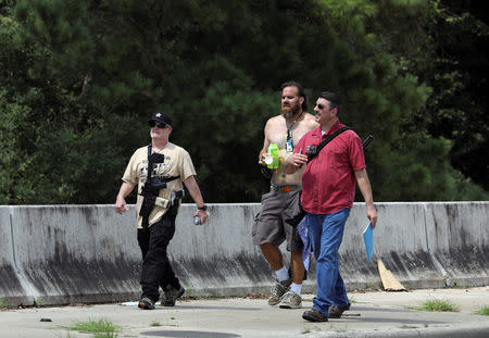 Open Carry Texas founder C.J. Grisham and fellow members, Joseph Walker and David Amad, openly carry firearms in Houston, Texas, U.S., September 24, 2018. Picture taken September 24, 2018. REUTERS/Loren Elliott