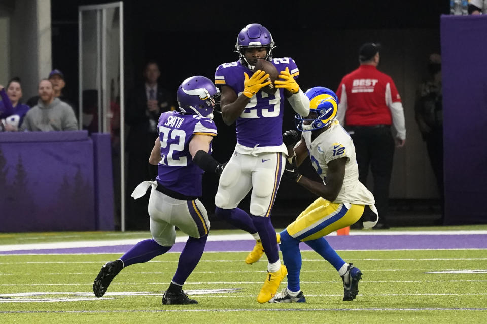 FILE - Minnesota Vikings free safety Xavier Woods (23) intercepts a pass intended for Los Angeles Rams wide receiver Van Jefferson, right, during the second half of an NFL football game, Sunday, Dec. 26, 2021, in Minneapolis. The Carolina Panthers have agreed to terms on a three-year, $15.75 million contract with free-agent safety Xavier Woods, according to a person familiar with the situation, Monday, March 14, 2022. (AP Photo/Jim Mone, File)