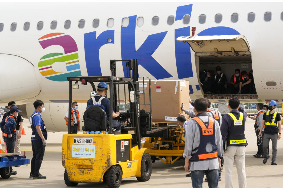 A batch of the Pfizer COVID-19 vaccines sent by Israel is unloaded at the Incheon International Airport in Incheon, South Korea, Wednesday, July 7, 2021. South Korea on Wednesday received 700,000 Pfizer shots from Israel in exchange for a future shipment of vaccines to Israel from September to November, when officials hope South Korea's shortage will have eased. (AP Photo/Ahn Young-joon)