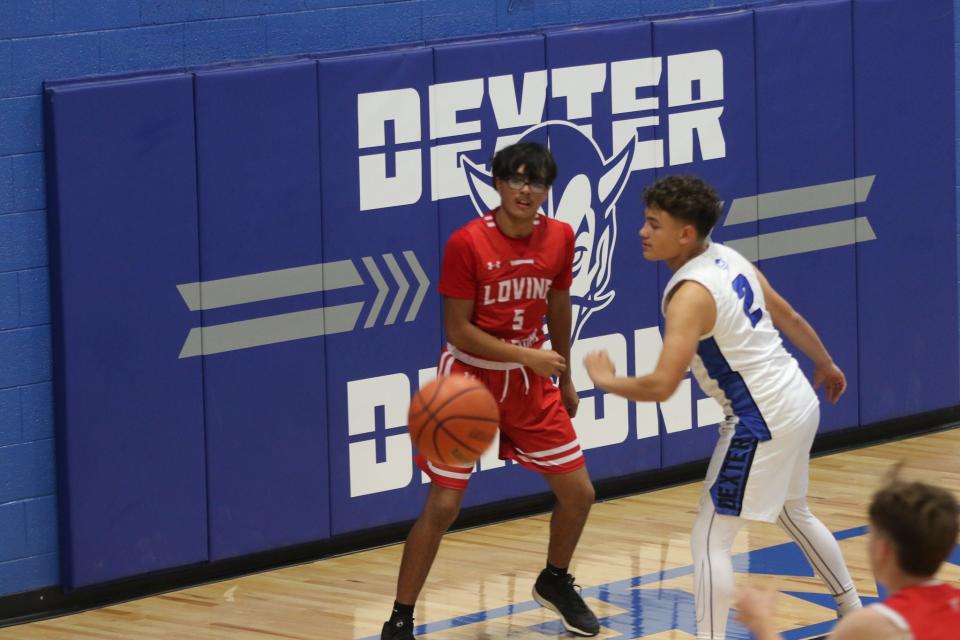 Loving's Kysiah Lujan inbounds a pass against the Dexter Demons during the Dec. 5, 2023 season opener in Dexter.