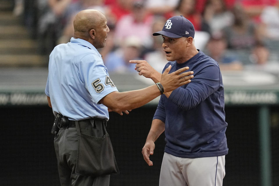 Tampa Bay Rays manager Kevin Cash, right, argues with home plate umpire CB Bucknor, left, in the fifth inning of a baseball game against the Cleveland Guardians, Saturday, Sept. 2, 2023, in Cleveland. Cash was ejected from the game. (AP Photo/Sue Ogrocki)