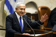 Israeli Prime Minister-designate Benjamin Netanyahu speaks during a special session of the Knesset, Israel's parliament, to approve and swear in a new right-wing government, in Jerusalem Thursday, Dec. 29, 2022. Netanyahu was set to return to office Thursday at the helm of the most religious and ultranationalist government in Israel’s history, vowing to implement policies that could cause domestic and regional turmoil and alienate the country’s closest allies.(Amir Cohen/Pool Photo via AP)
