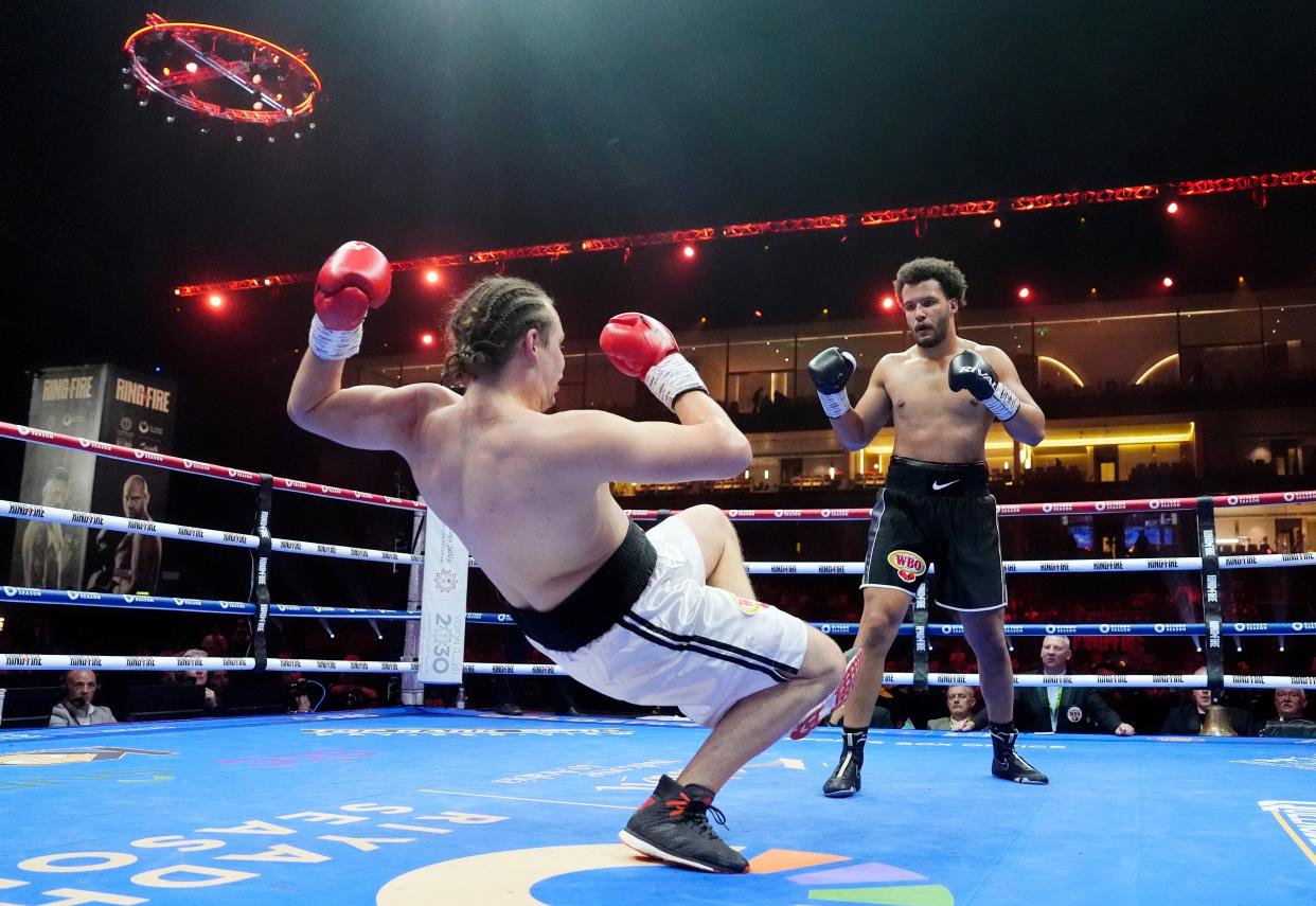 Moses Itauma (right) knocks down Ilja Mezencev (Nick Potts/PA Wire)