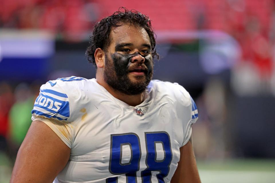 Detroit Lions defensive tackle John Penisini (98) walks off of the field after their loss Dec. 26, 2021 against the Atlanta Falcons at Mercedes-Benz Stadium.