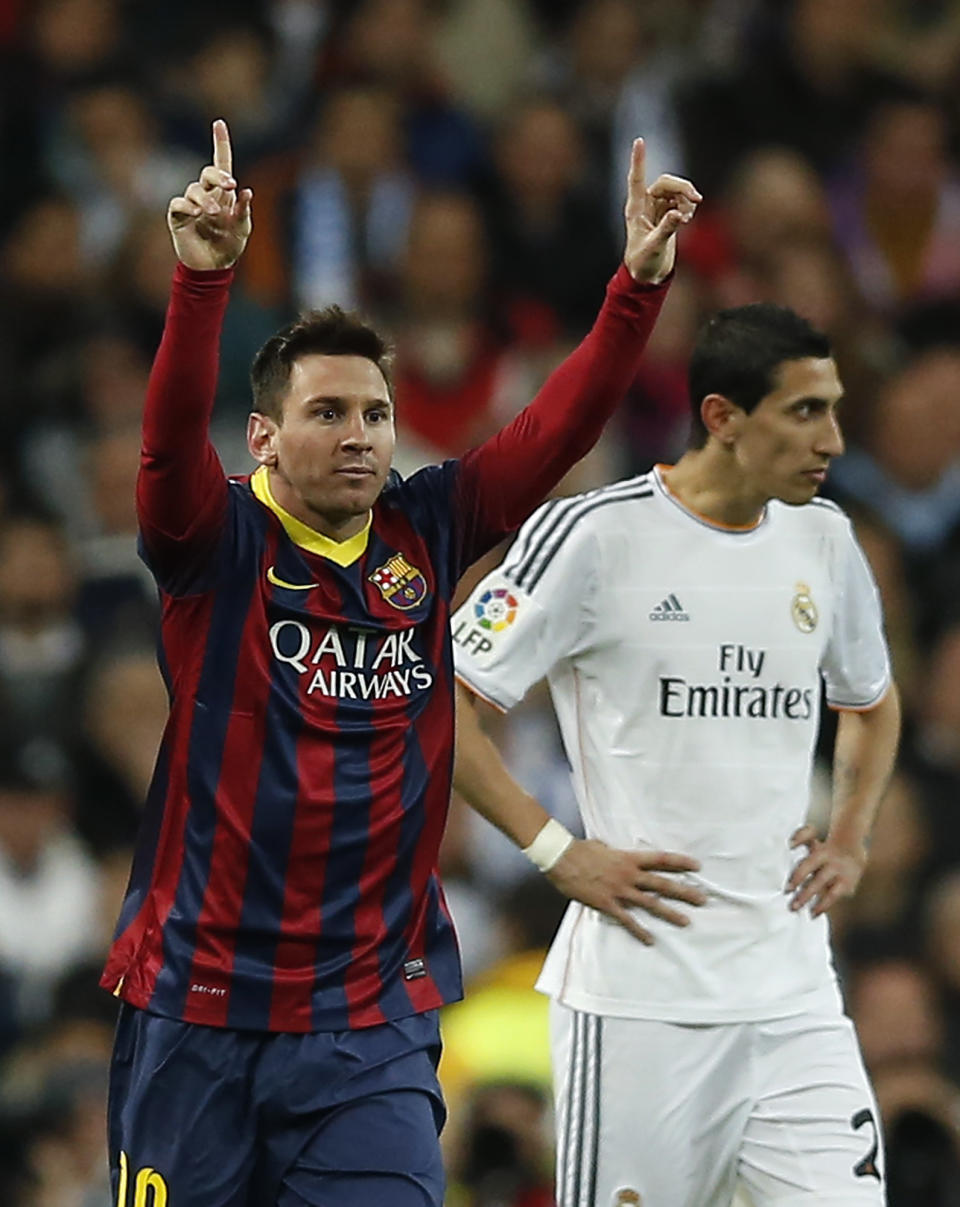 Barcelona's Lionel Messi from Argentina, left, celebrates his goal next Real's Angel Di Maria, right, during a Spanish La Liga soccer match between Real Madrid and FC Barcelona at the Santiago Bernabeu stadium in Madrid, Spain, Sunday, March 23, 2014. (AP Photo/Andres Kudacki)