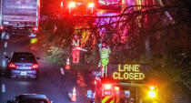 Authorities work to clear a fallen tree that is blocking a lane on I-20 at Langhorn Street in Atlanta on Thursday morning, Oct. 29, 2020. Tropical Storm Zeta sped across the Southeast on Thursday, leaving a trail of damage and more than 2 million homes and businesses in the dark in Atlanta. (John Spink/Atlanta Journal-Constitution via AP)