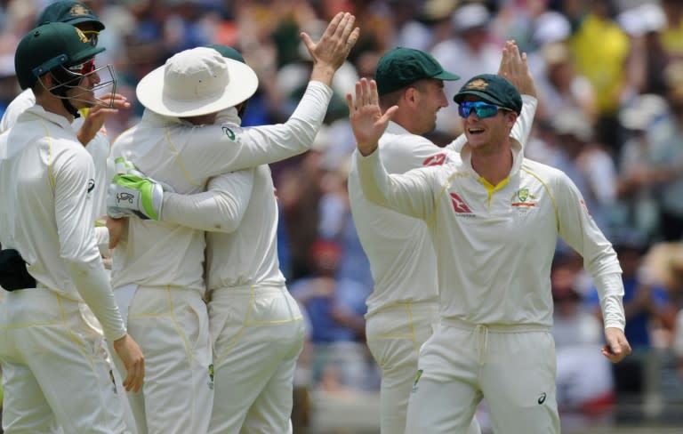 Australian players celebrate the dismissal of England's Dawid Malan on day two of their third Ashes Test match, in Perth, on December 15, 2017