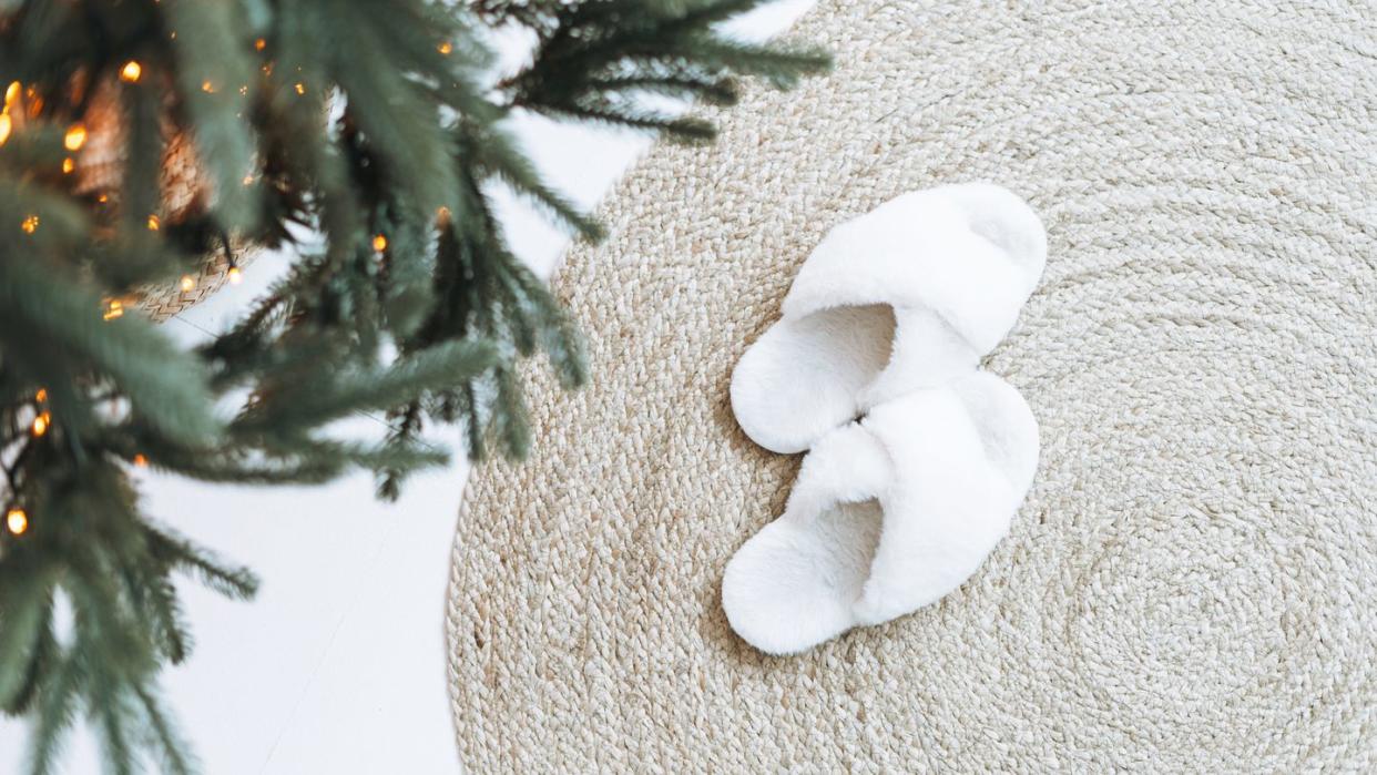 cozy fluffy slippers on natural rug near christmas tree,yekaterinburg,sverdlovsk oblast,russia