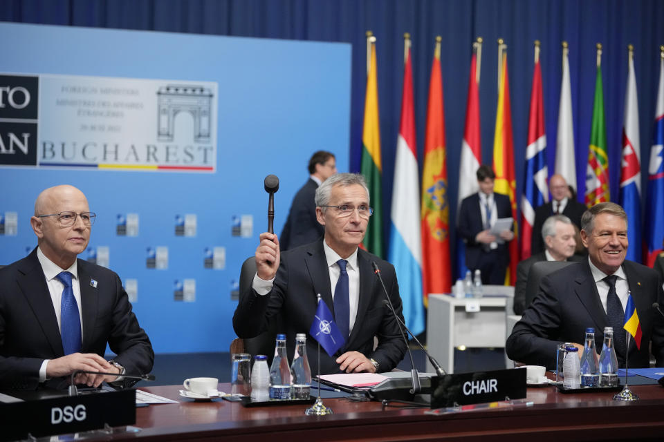 NATO Secretary-General Jens Stoltenberg , center, opens the first day of the meeting of NATO Ministers of Foreign Affairs, in Bucharest, Romania, Tuesday, Nov. 29, 2022. (AP Photo/Andreea Alexandru)