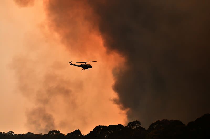 A helicopter is seen during a bushfire near Bilpin