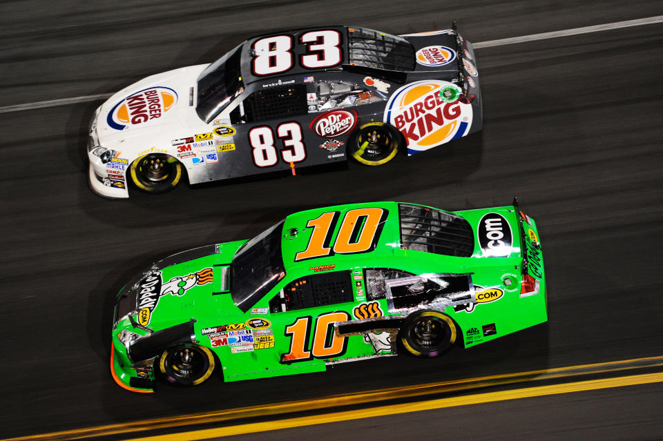 DAYTONA BEACH, FL - FEBRUARY 27: Landon Cassill, driver of the #83 Burger King Toyota, and Danica Patrick, driver of the #10 GoDaddy.com Chevrolet, race during the NASCAR Sprint Cup Series Daytona 500 at Daytona International Speedway on February 27, 2012 in Daytona Beach, Florida. (Photo by John Harrelson/Getty Images for NASCAR)