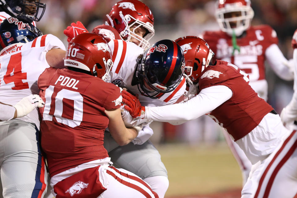 Nov 19, 2022; Fayetteville, Arkansas, USA; Ole Miss Rebels quarterback Jaxson Dart (2) is tackled by Arkansas Razorbacks linebacker Bumper Pool (10) in the first quarter at Donald W. Reynolds Razorback Stadium. Mandatory Credit: Nelson Chenault-USA TODAY Sports