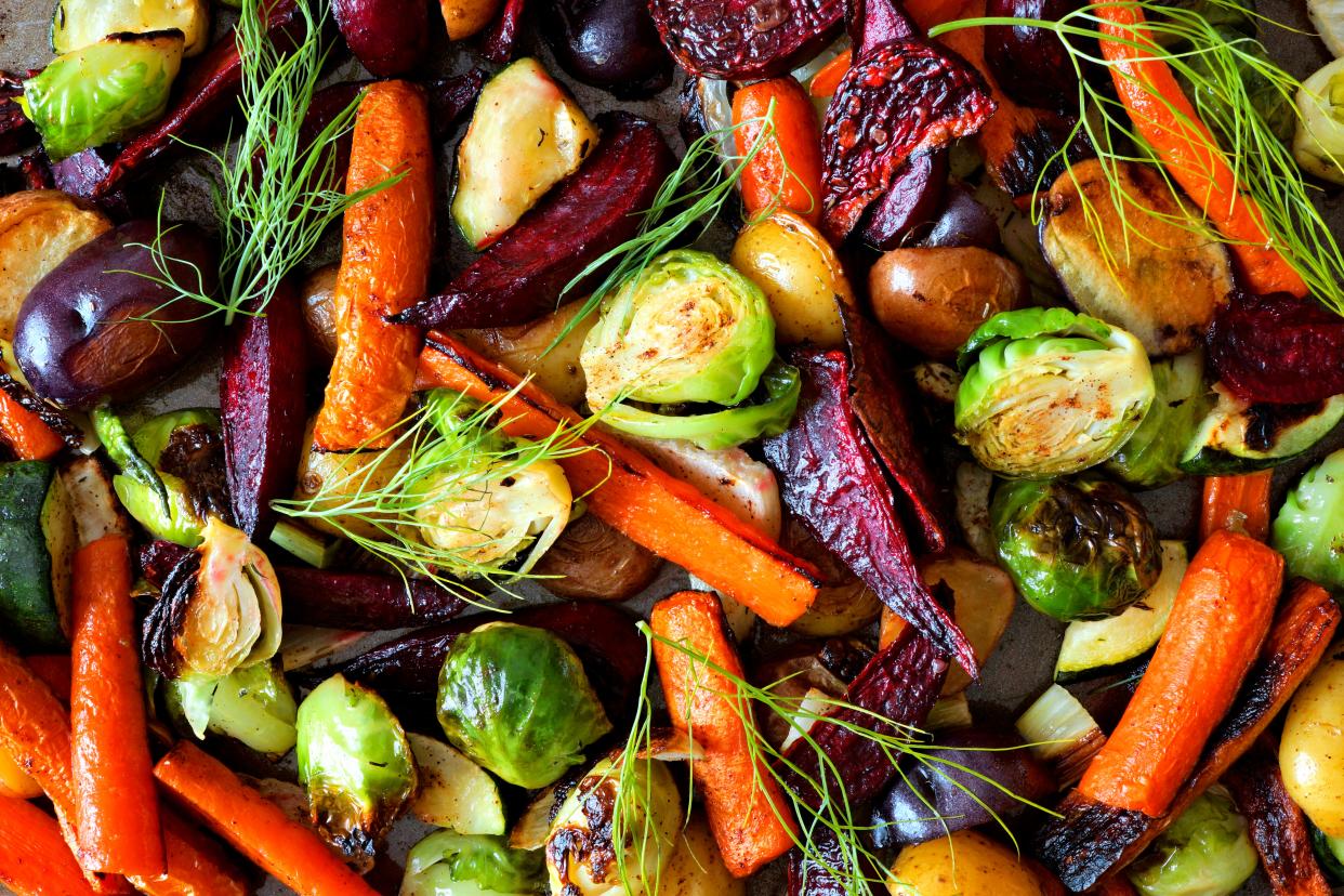 Full background of colorful roasted autumn vegetables, including sprouts. (Getty Images)