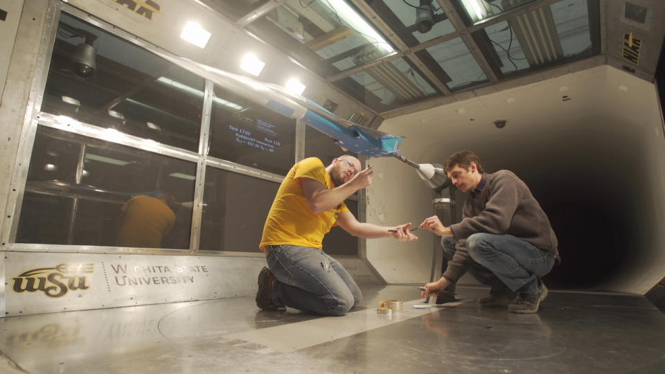 Several employees work in the wind tunnel with a model of one of the supersonic aircraft that is developing Boom. Photo courtesy of Boom Company.