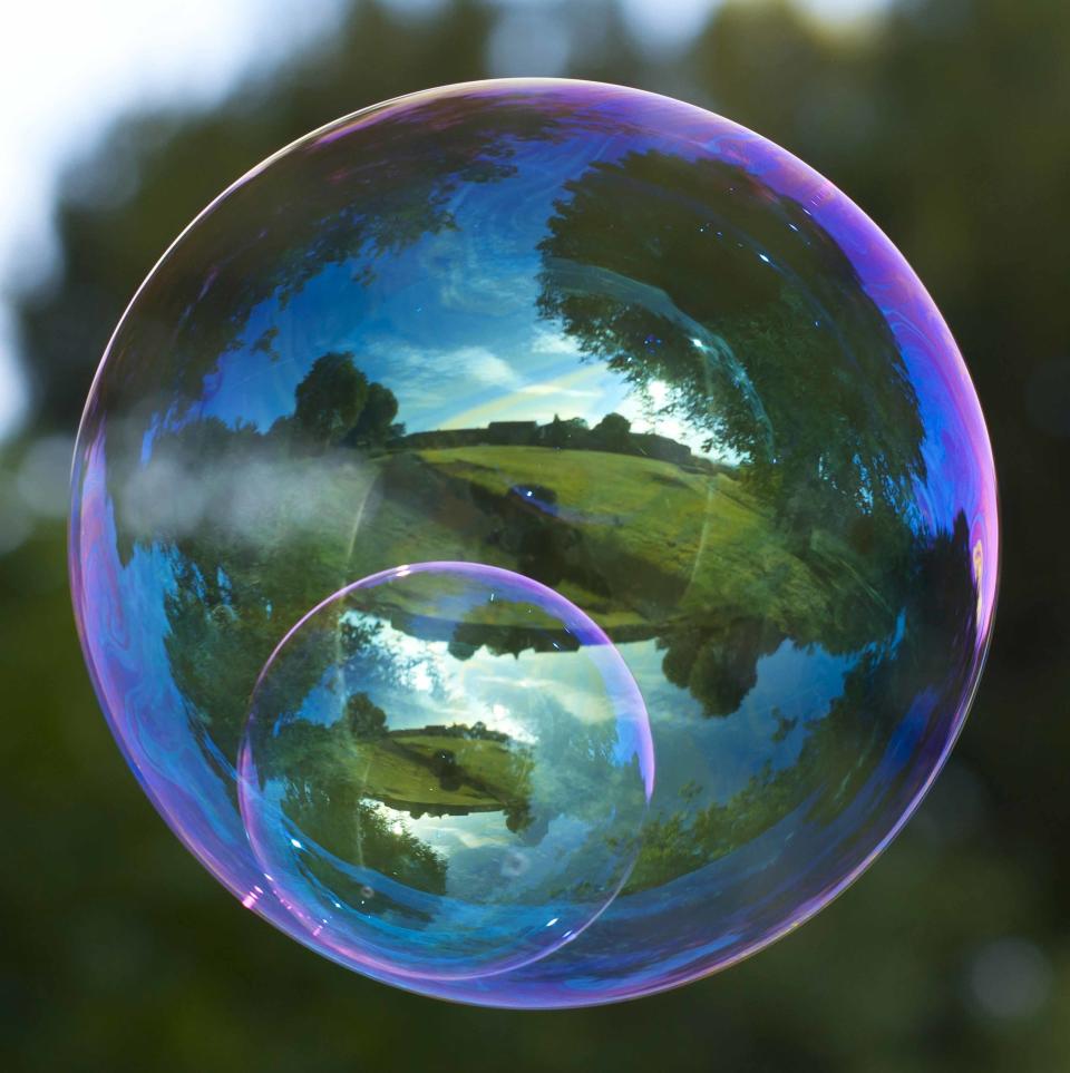 This incredible series of images captured in the reflection of a bubble is enough to blow your mind.
