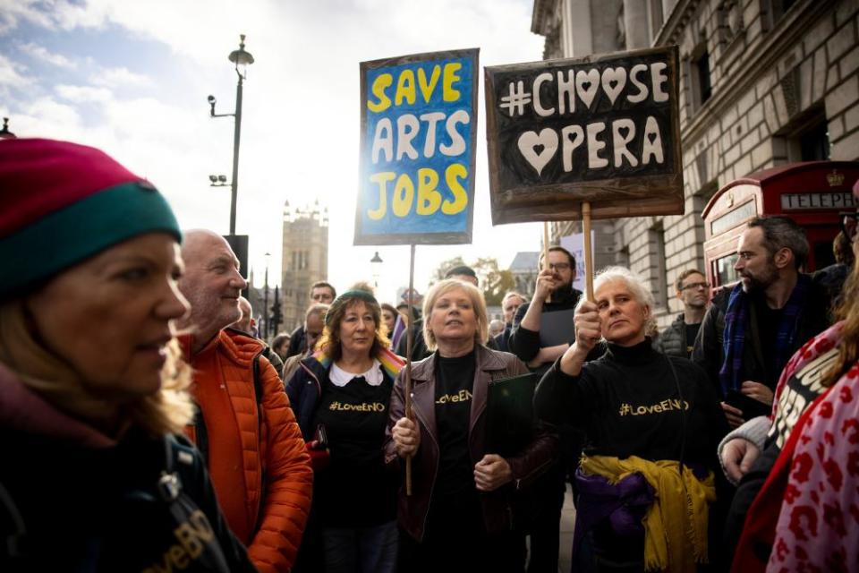 A crowd holding placards reading ‘Save Arts Jobs’ and ‘Choose Opera’