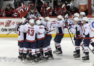 The Washington Capitals celebrate with Alex Ovechkin (8) after he scored his 700th career goal during the third period of an NHL hockey game against the New Jersey Devils Saturday, Feb. 22, 2020, in Newark, N.J. (AP Photo/Bill Kostroun)