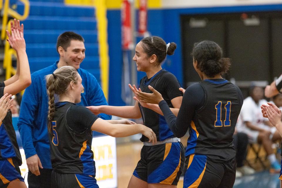 Devyn Quigley gets congratulations from her coach and teammate after breaking scoring record. Manchester Girls Basketball advances in state tournament play against Overbrook as Devyn Quigley surpassed the all-time scoring record on the Shore.