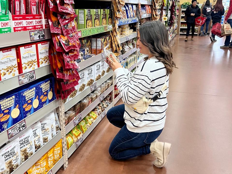 The writer reads a label on a product at Trader Joe's