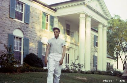 © EPE via memphistravel.com An early photo of Elvis Presley walking on the grounds at his Graceland estate in Memphis, Tennessee