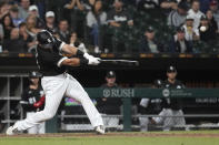 Chicago White Sox's Jake Burger hits a three-run home run off Boston Red Sox starting pitcher Rich Hill during the fifth inning of a baseball game Wednesday, May 25, 2022, in Chicago. (AP Photo/Charles Rex Arbogast)