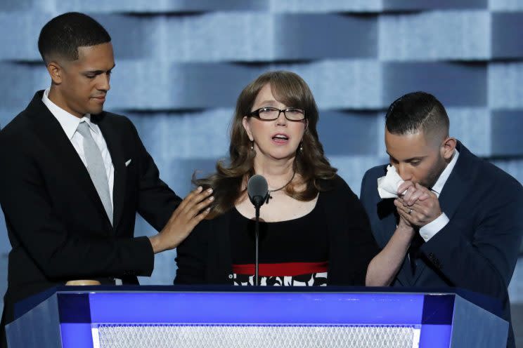 Christine Leinonen, the mother of a young man who was killed in the nightclub attack in Orlando last month, is joined on stage by two survivors: Brandon Wolf and Jose Arraigada, during the third day of the Democratic National Convention. (Photo: J. Scott Applewhite/AP)