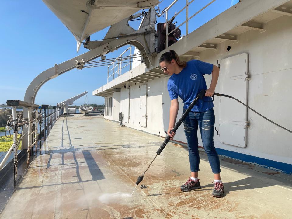 Girl washing floor on boat