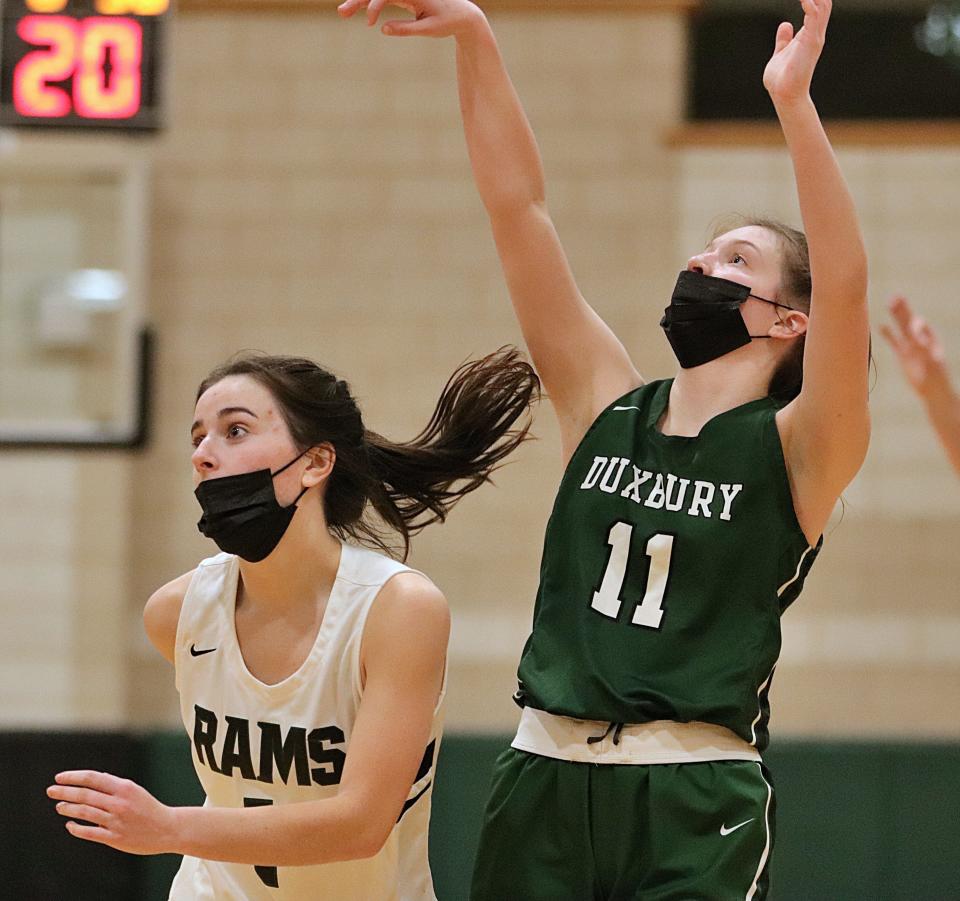 Duxbury's Lyla Peters follows through on a three-pointer during a game against Marshfield at Marshfield High School on Friday, Jan. 28, 2022.