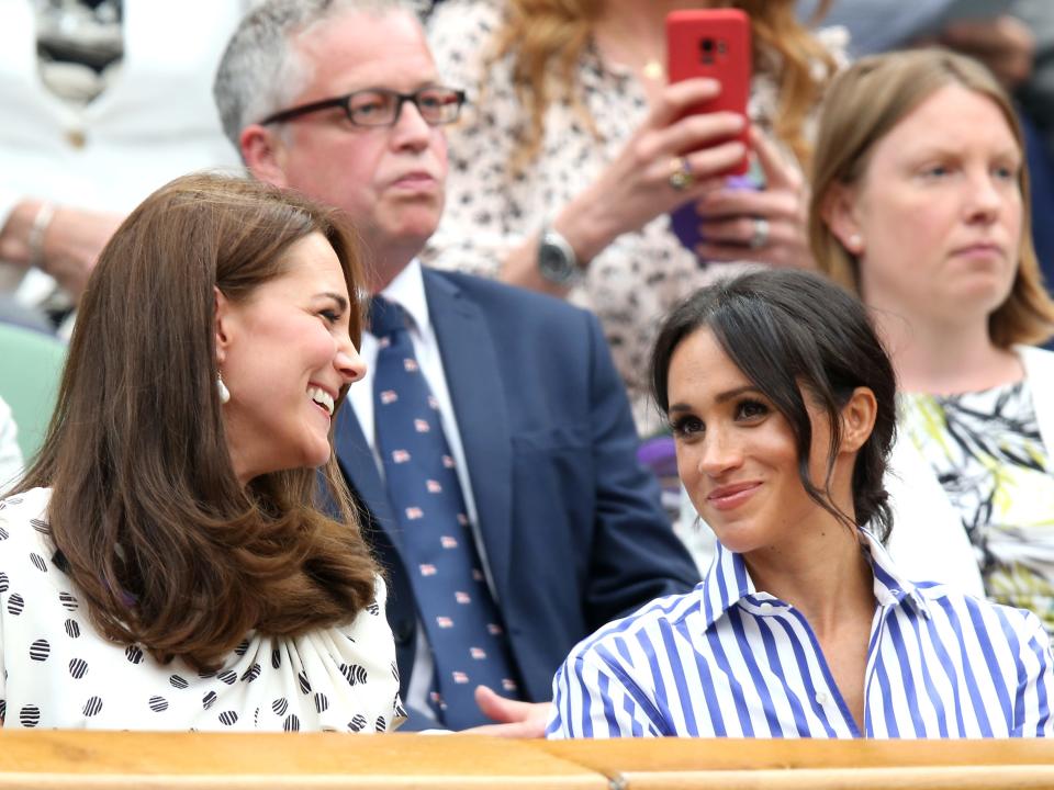 Kate Middleton and Meghan Markle in the royal box on centre court on day twelve of the Wimbledon Championships at the All England Lawn Tennis and Croquet Club, Wimbledon on July 14, 2018.