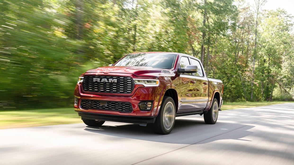 red pickup truck driving down a road